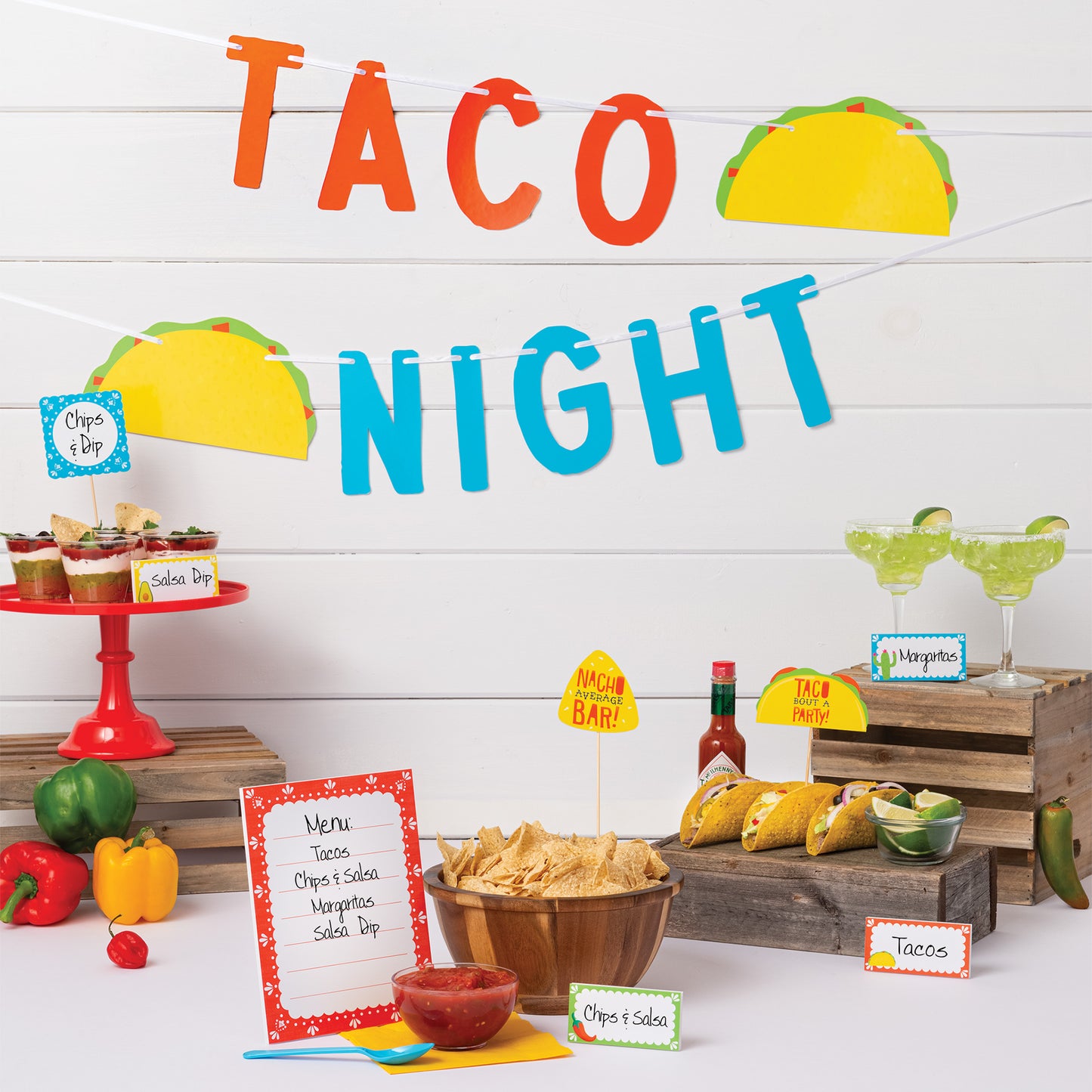 Decorated table for a taco night party with food and decorations.