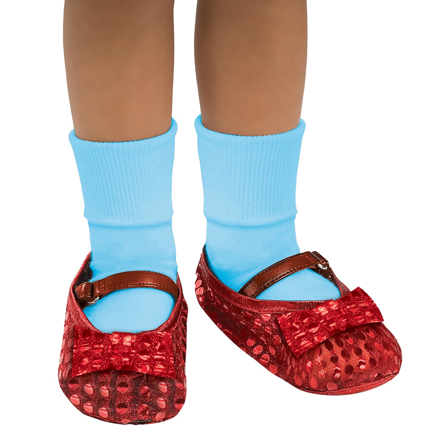 Red glittery shoes with a bow and blue socks on a white background