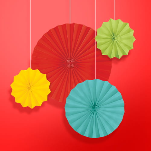 Four hanging, pleated paper fans in red, yellow, green, and blue are displayed against a solid red background.