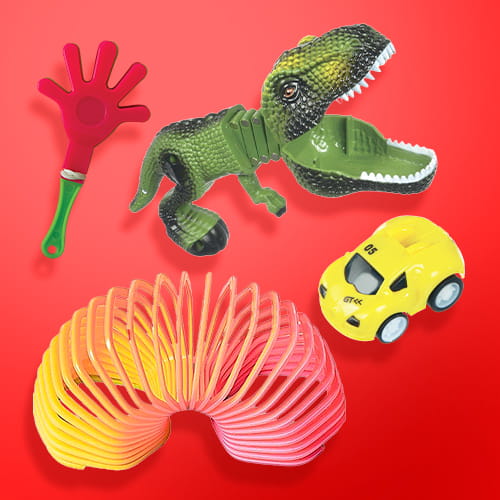 A collection of colorful children's party favors, including a red hand clapper, a green dinosaur grabber, a yellow toy car, and a multi-colored spring toy, displayed against a red background.