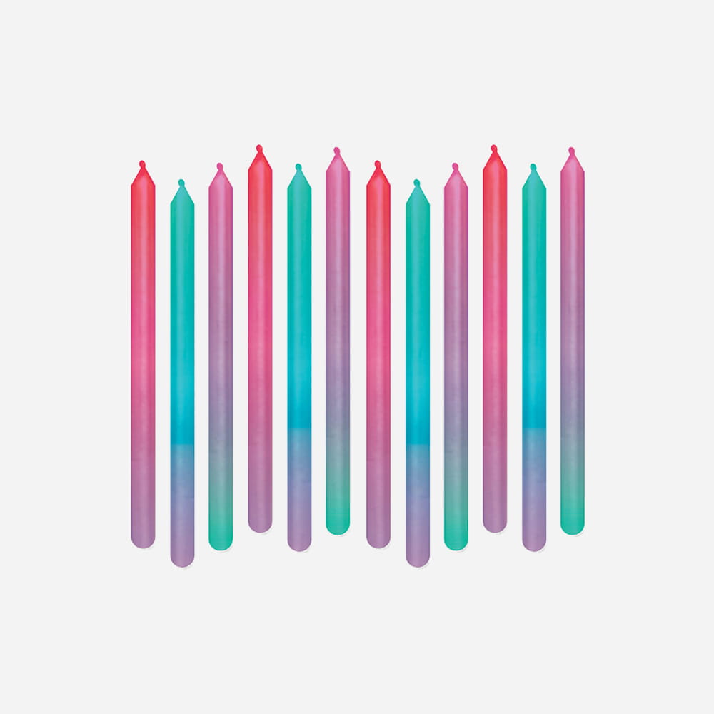 A row of twelve slim, colorful birthday candles with vibrant gradients of pink, teal, and purple against a light gray background.
