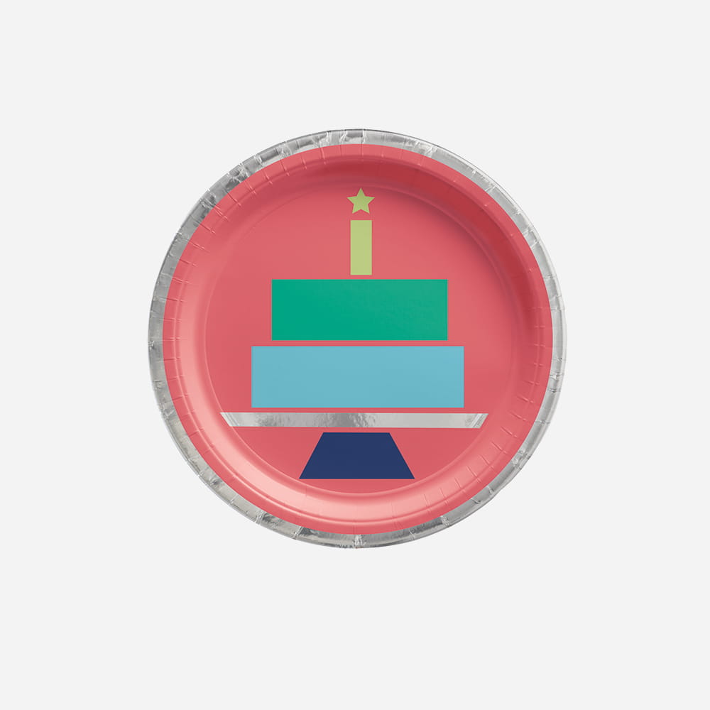 A pink paper plate with a silver foil rim featuring a minimalist, geometric illustration of a multi-tiered birthday cake on a stand.